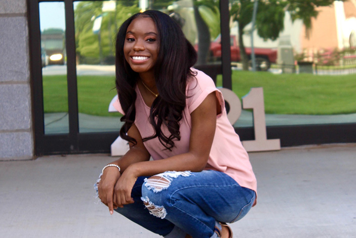 Amara Jackson, 19, was born with HIV and takes a pill every day to keep the virus under control.